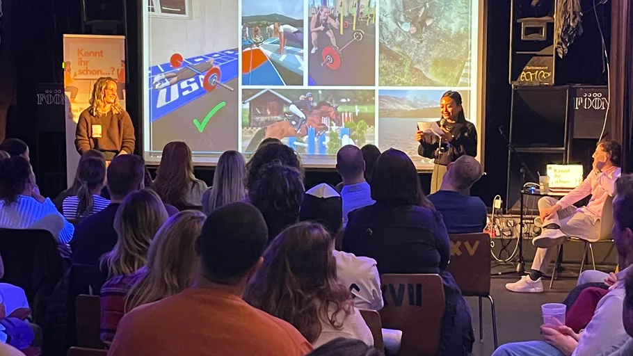 People watching a slideshow presentation in a room.