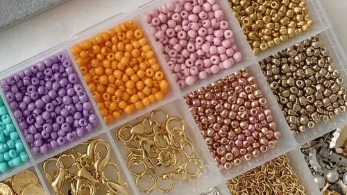 Colorful beads organized in a plastic box.