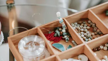 Beads organized in a wooden craft box.