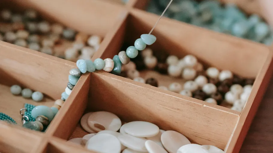 Beads are organized in a wooden box.
