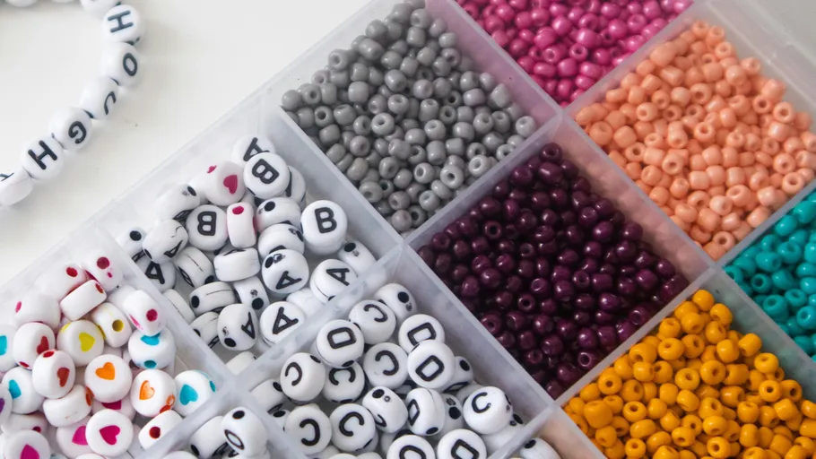 Colorful beads organized in a box.