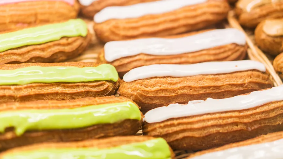 Eclairs with white and green icing displayed.