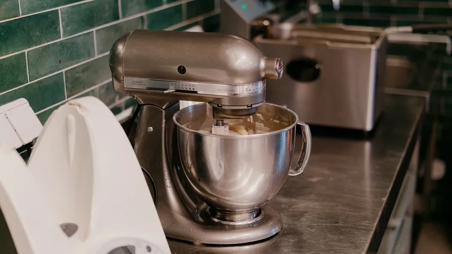 Mixer blending ingredients in a kitchen.