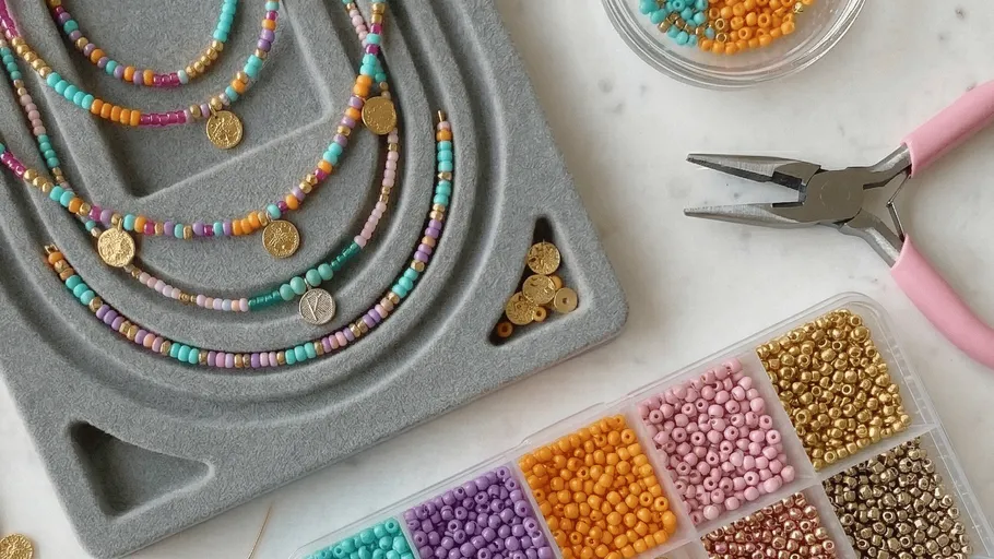 Beaded necklaces with tools on a crafting table.