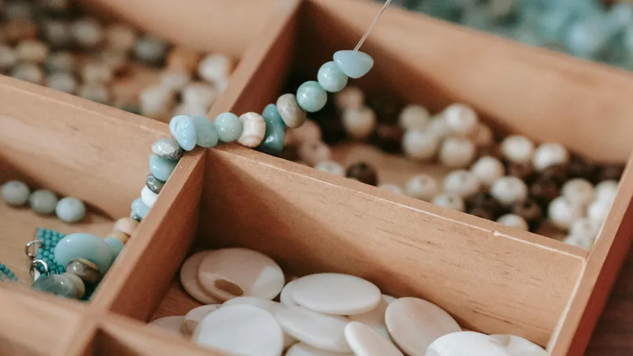 Beads in a wooden organizer, some strung.