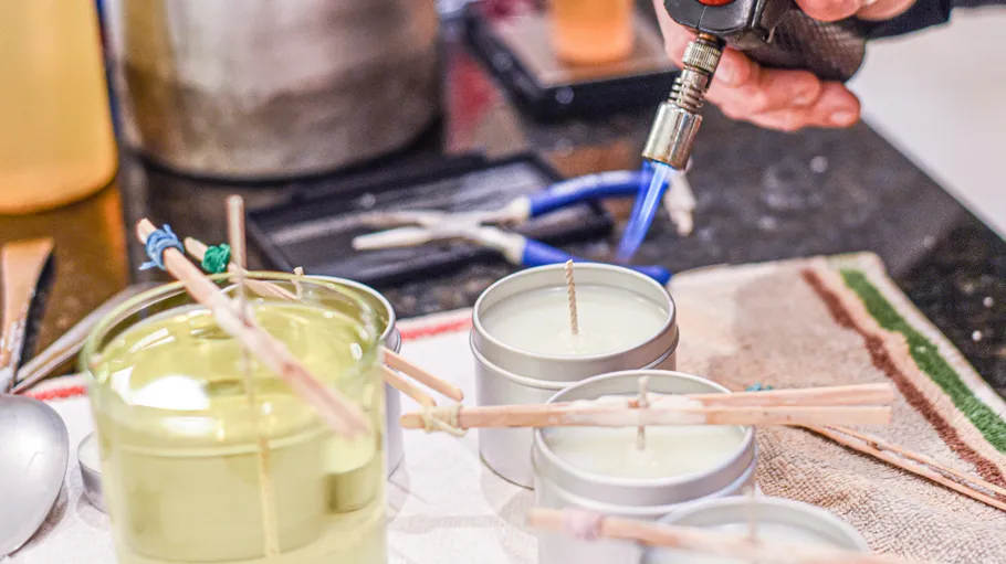 Person using torch to craft candles.