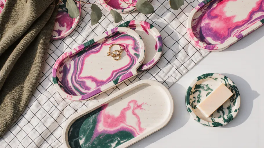 Colorful marbled trays with rings and soap.