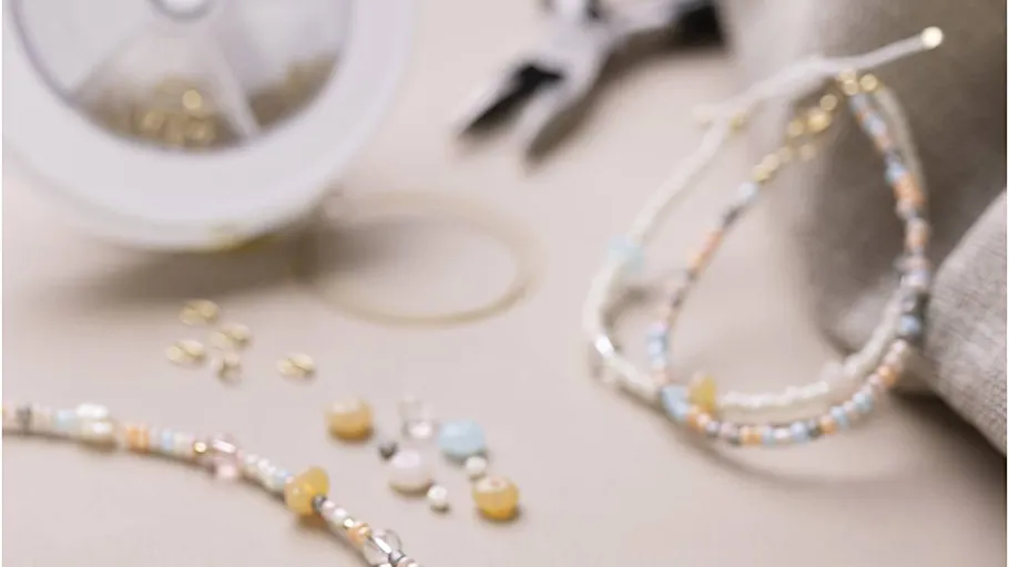 Beaded bracelets with jewelry-making tools nearby.