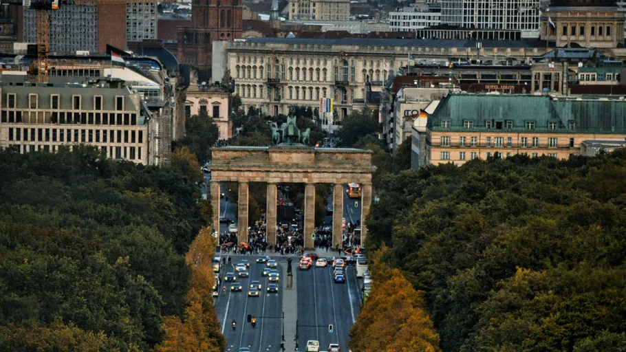 Brandenburg Gate surrounded by city buildings.