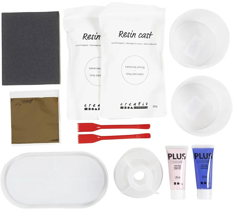 Resin casting kit with tools on white background.