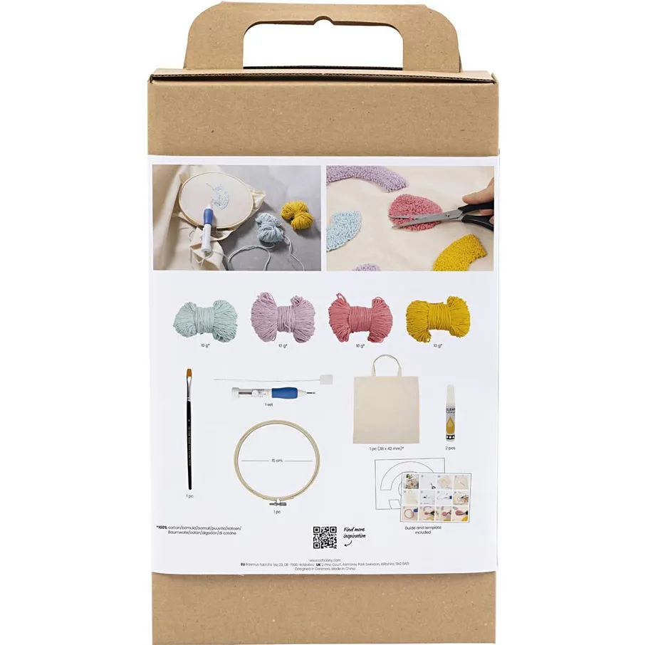 Embroidery kit with yarn and tools displayed.