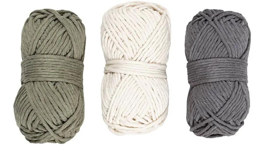 Three yarn skeins in green, white, and gray.