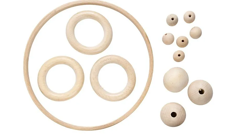Wooden rings and beads on white background.