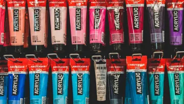 Acrylic paint tubes displayed on a shelf.