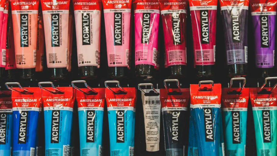 Acrylic paint tubes displayed on a shelf.