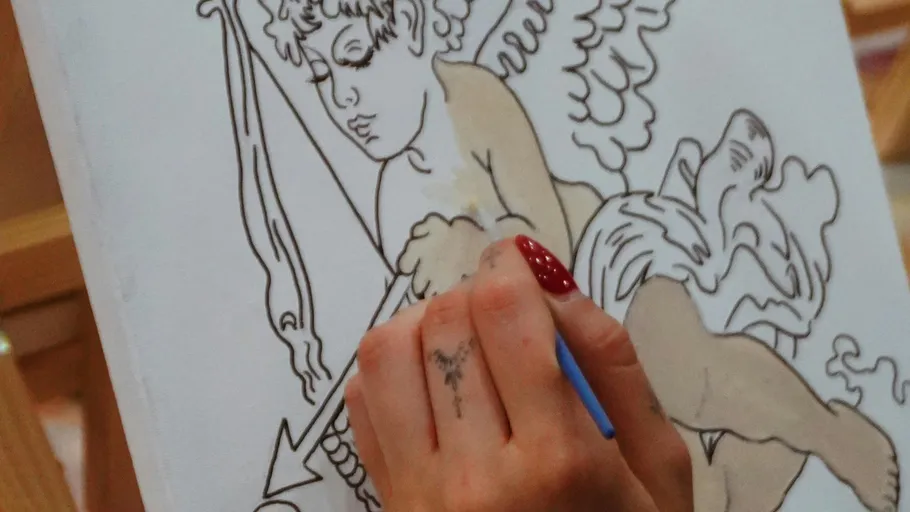 Hand painting cupid sketch on canvas.