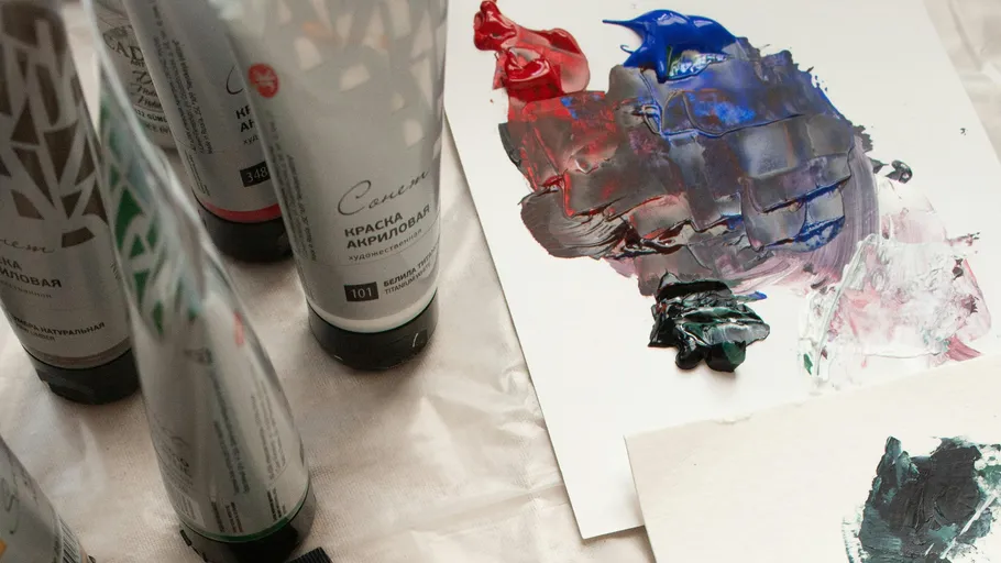 Farbtuben und gemischte Farben auf Papier.