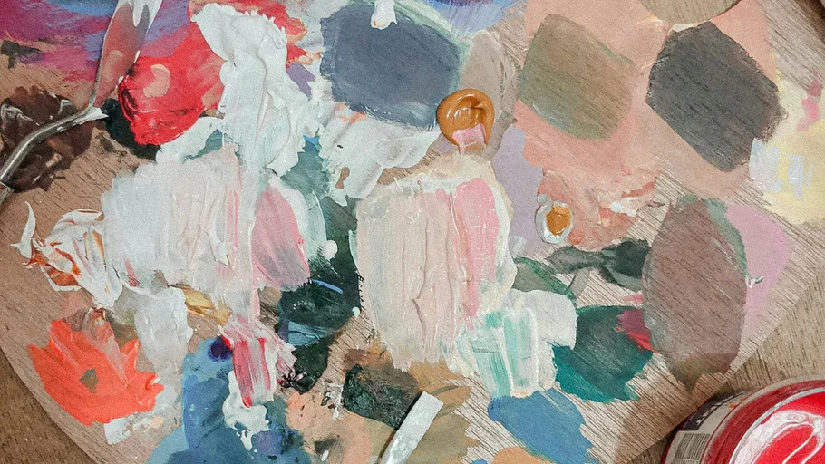 Wooden palette with mixed paint colors.