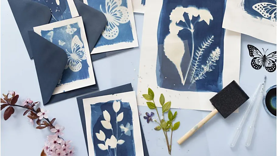 Cyanotype prints with flowers and butterflies.