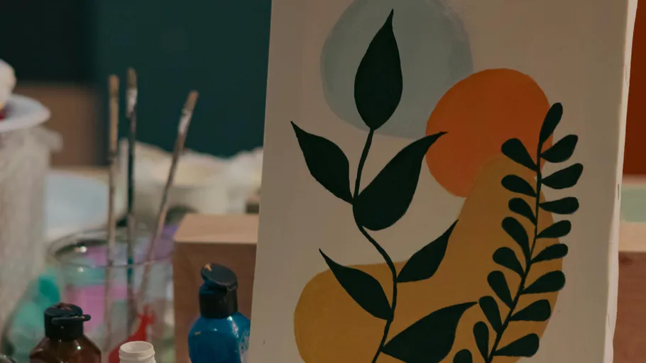 Abstract painting with leaves and colored shapes.