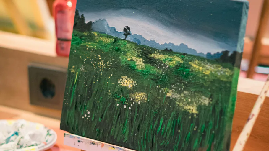 Landscape painting on easel in workshop.