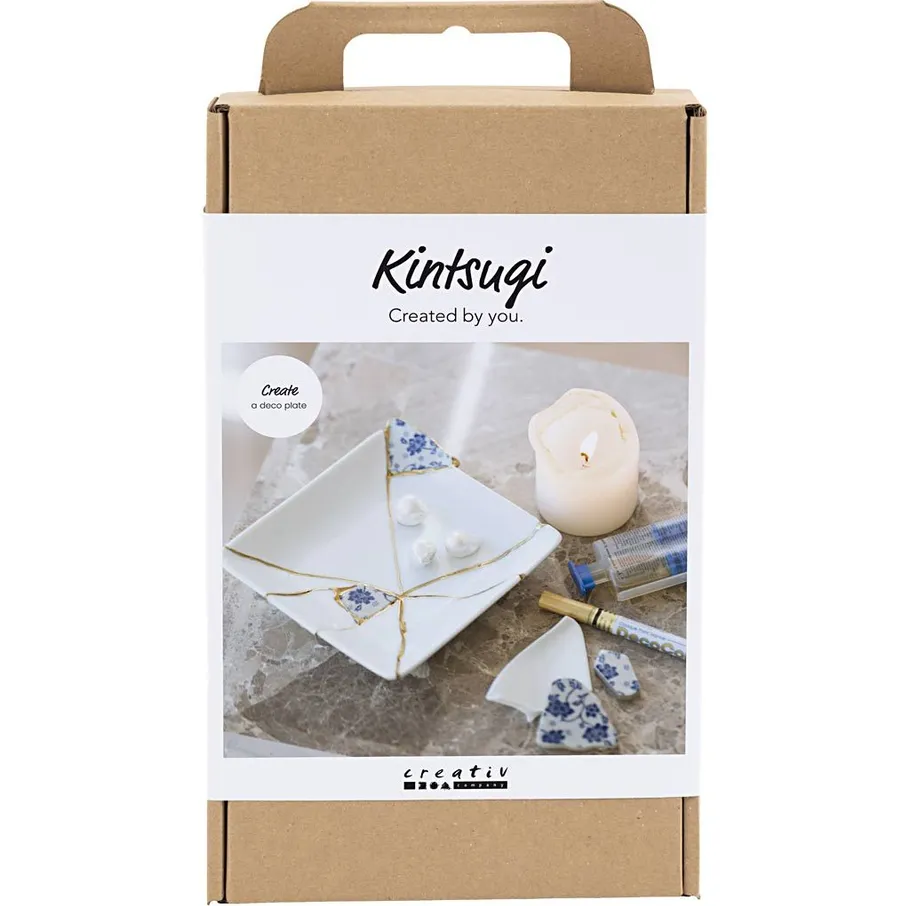 Kintsugi kit with repaired ceramic plate.