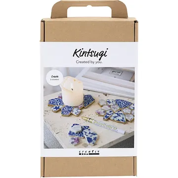 Kintsugi-Set mit Steinstücken und Kerze.