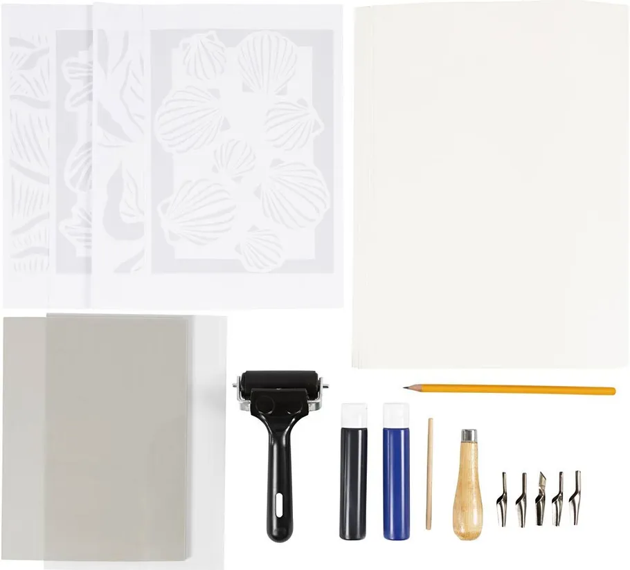 Printmaking kit with tools and papers displayed.