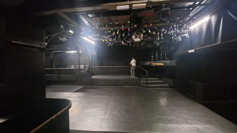 Empty nightclub interior with hanging lights.