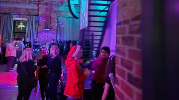 People socializing at a festive indoor event.