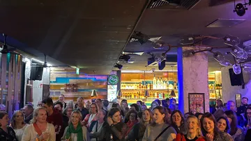 People gathered in a lively bar setting.