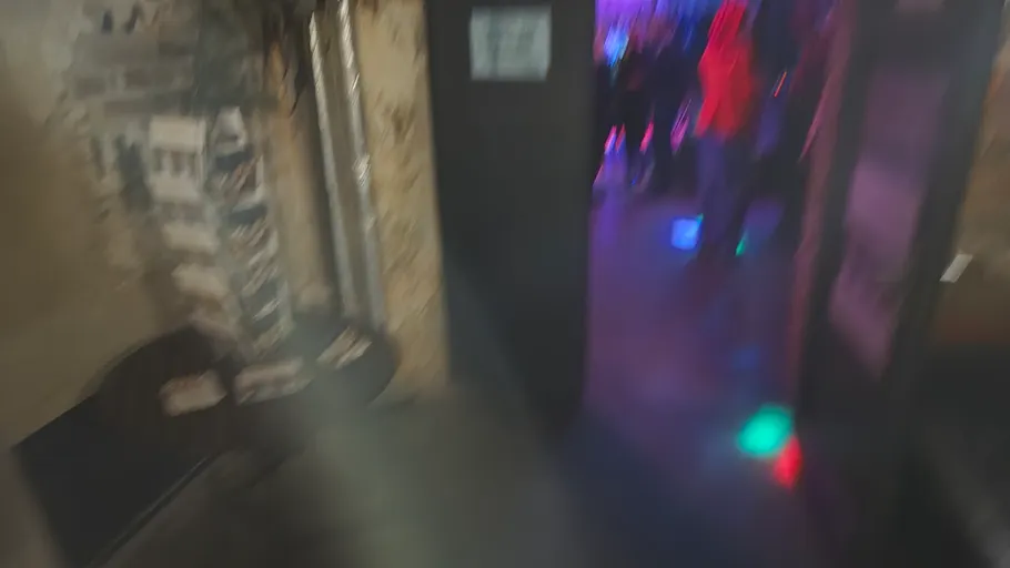 Blurred image of a dimly lit nightclub.