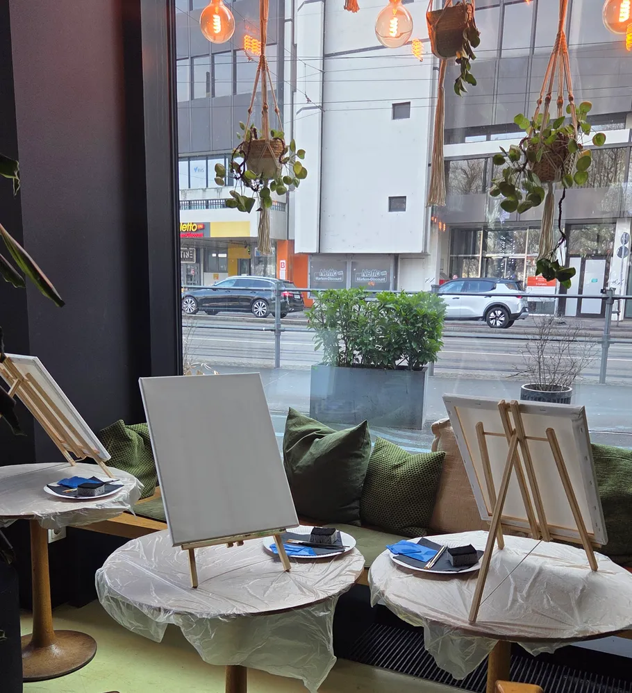 Empty easels set up in a cafe.