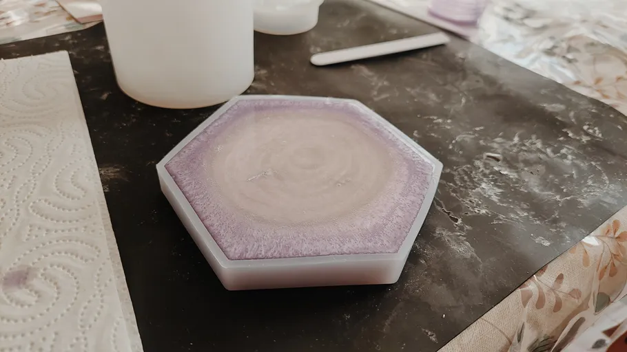 Hexagonal resin mold on a dark surface.