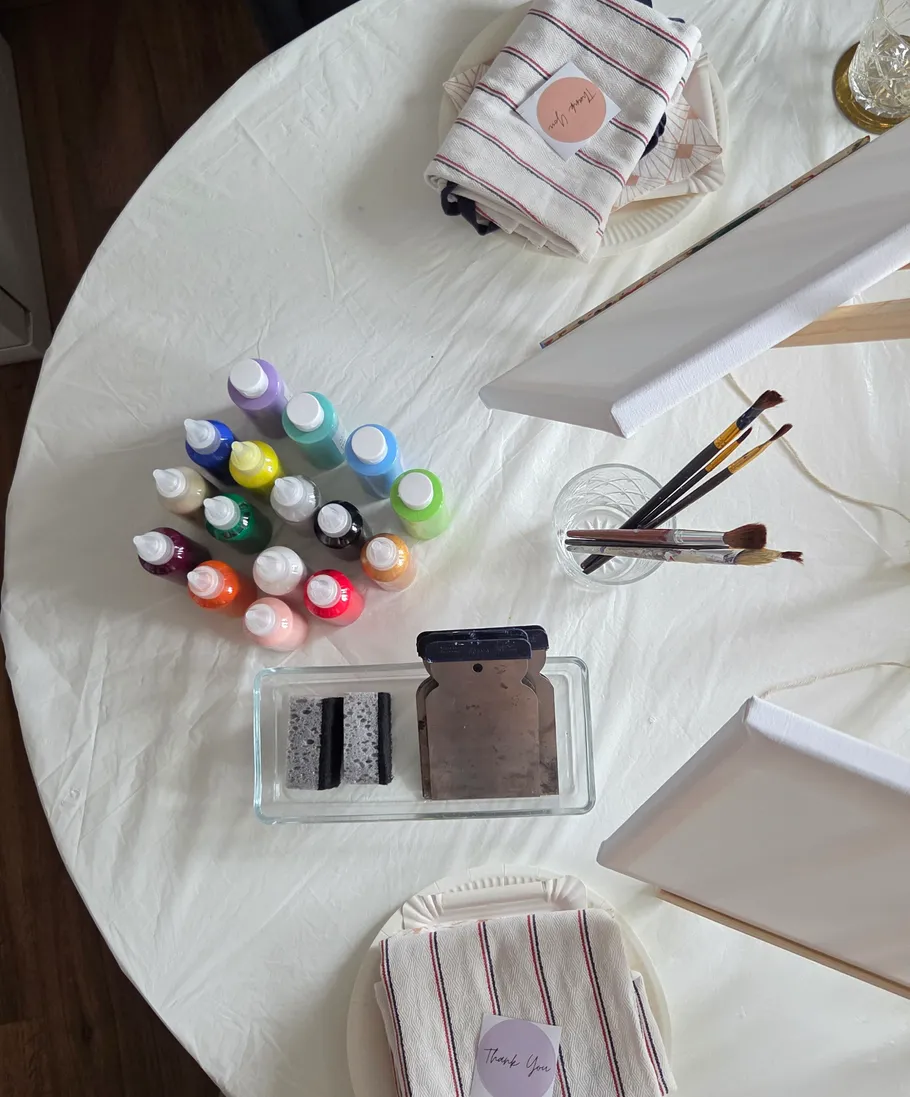 Art supplies on a round table, ready for painting.