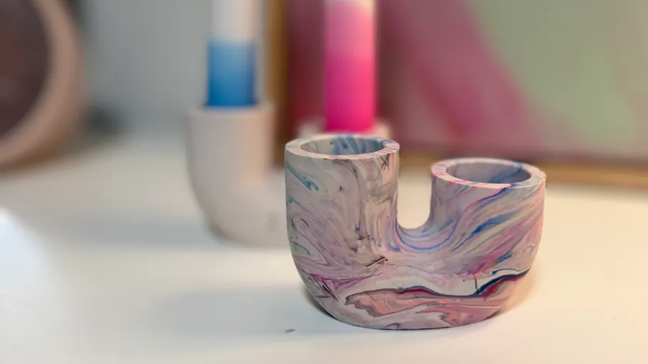 Colorful marbled candle holder on table.