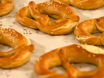 Pretzels lie on baking paper in a bakery.
