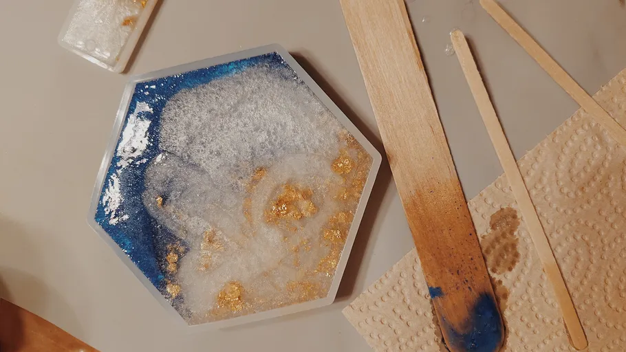 Hexagonal resin mold with gold and blue details.