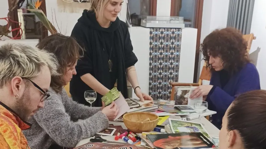 Group creating crafts at table indoors.