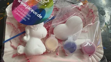 Unicorn painting kit with paints and brush.
