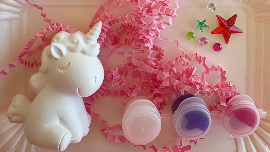 Unicorn toy with paint and decorative items.