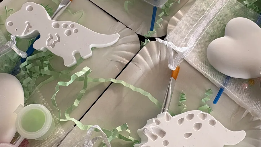 Dinosaur crafting kits with paint and brushes.