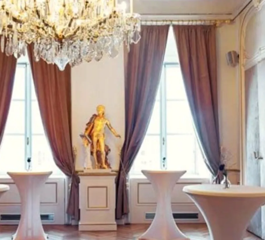 Elegant room with statue and chandelier.