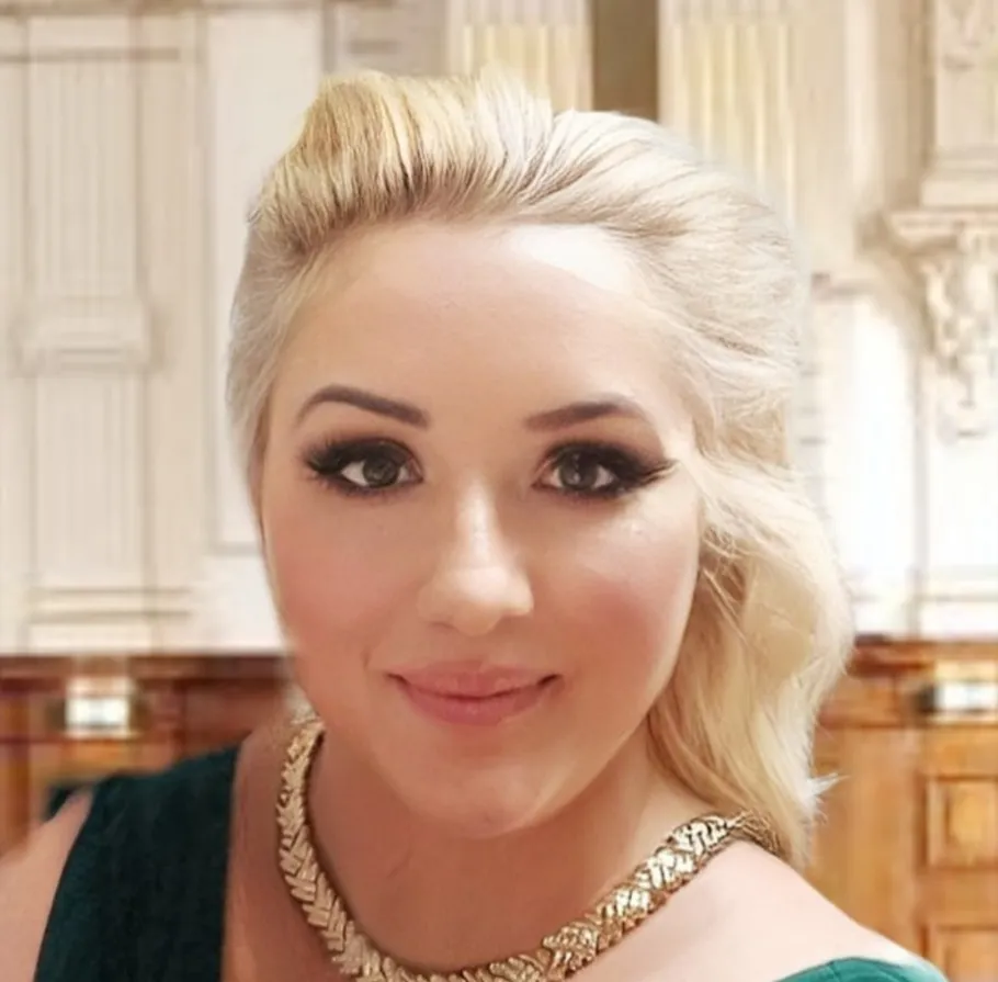 Smiling woman indoors with ornate background.