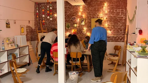 Group painting in cozy studio with fairy lights.