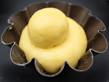 Yellow mass in a metal mold, ready for baking.