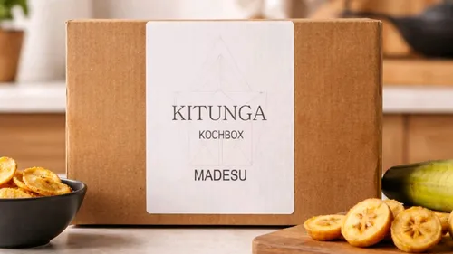 Cooking box labeled 'KITUNGA KOCHBOX MADESU' in kitchen.