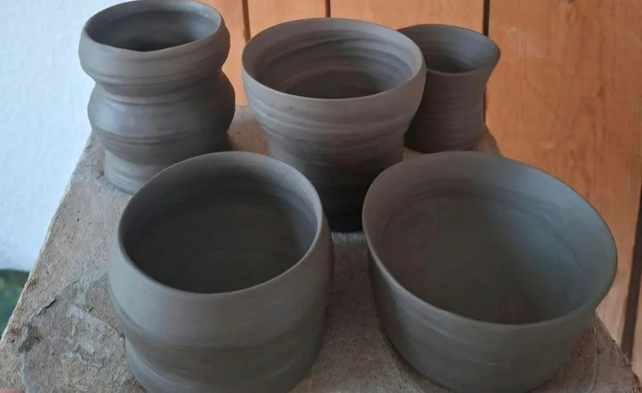 Clay pots arranged on a wooden surface.