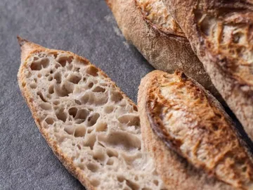 Sliced bread is laid on a grey background.