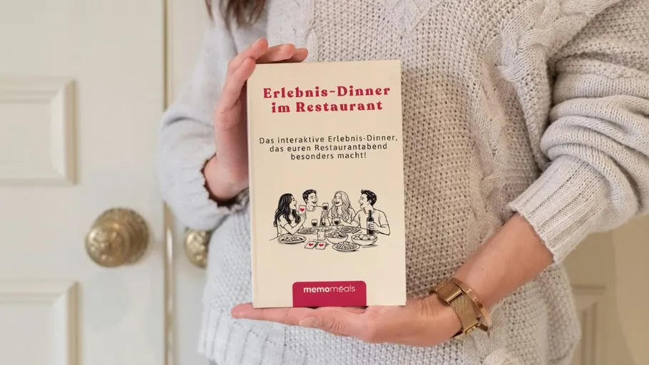 Person holding interactive dining book indoors.